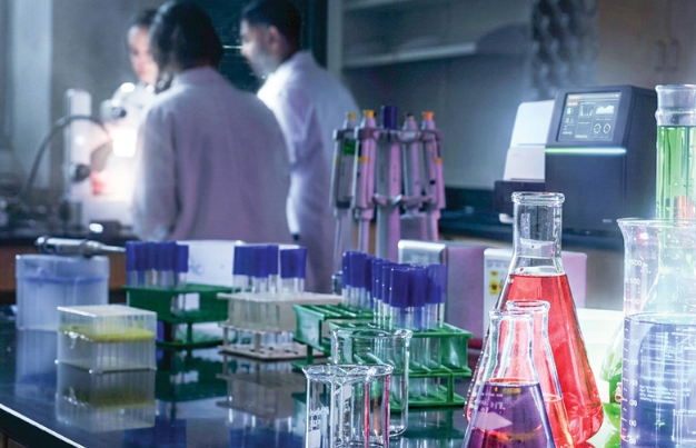 Inside the lab with 3 students at night.